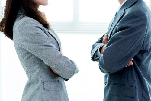 Two businesspeople standing face to face partnership dispute attorney