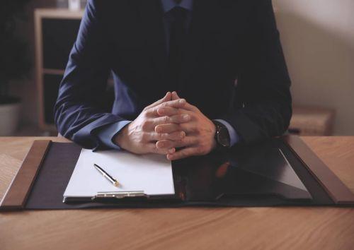 Male lawyer at table in office, closeup Concept for LLC Member Oppression Claims/