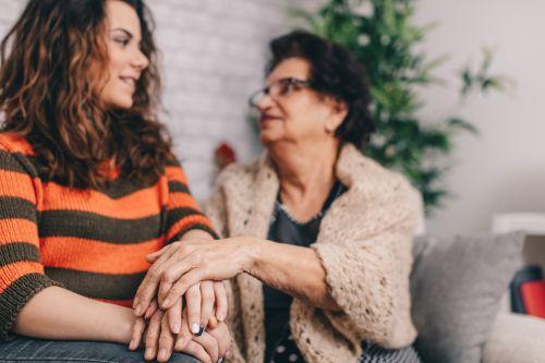 Mother and daughter talking. Focus on hands. Legal concept for Challenging a Trust for Lack of Capacity or Undue Influence