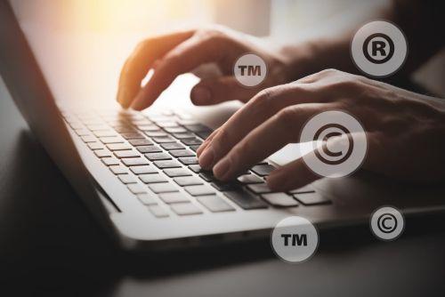Concept of Trade Secret Protection material. Copyright, registered symbols with laptop composition